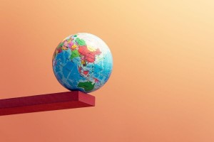 A globe balancing on the edge of a beam (Getty Images/Daniel Grizelj)