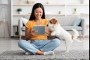 girl and dog looking at ipad