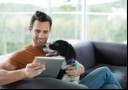 man with dog looking at ipad